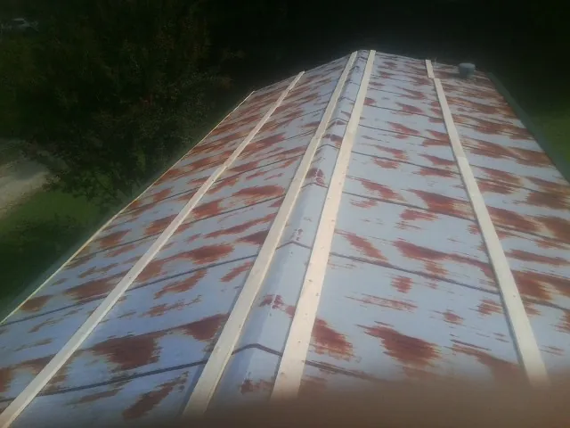 Rusted metal roof panels with new wood purlins before replacement — Storm Damage Roof Repair in Timberlake by Roofing Brothers